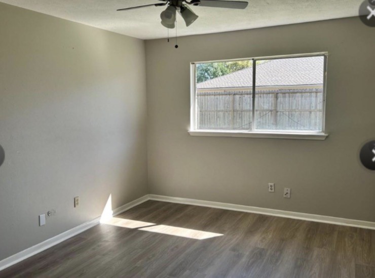 4515 Seneca Street Pasadena, TX 77504 - Photo 8 of 18 an empty room with wooden floor and windows