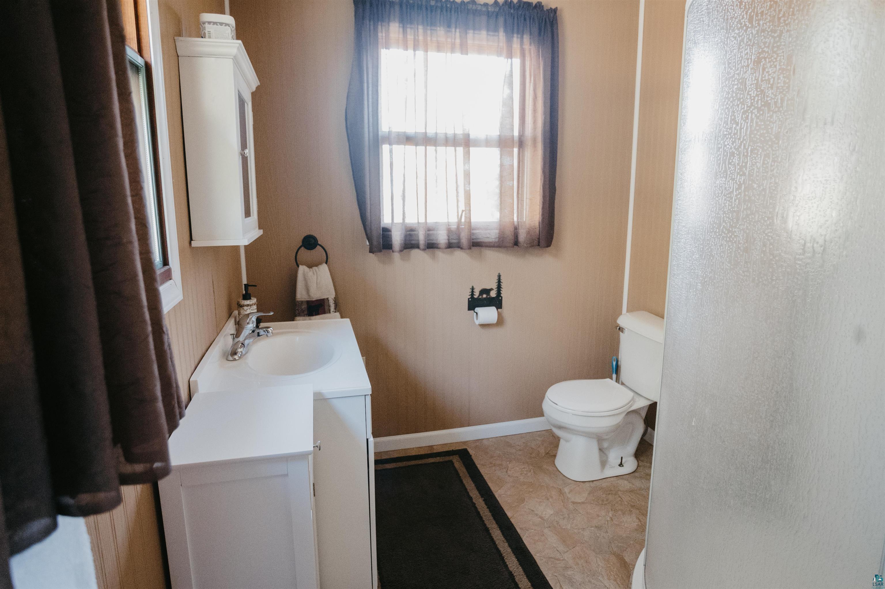 2308 South Weiberg Point Road Makinen, MN 55763 - Photo 17 of 33 Bathroom featuring vanity and toilet