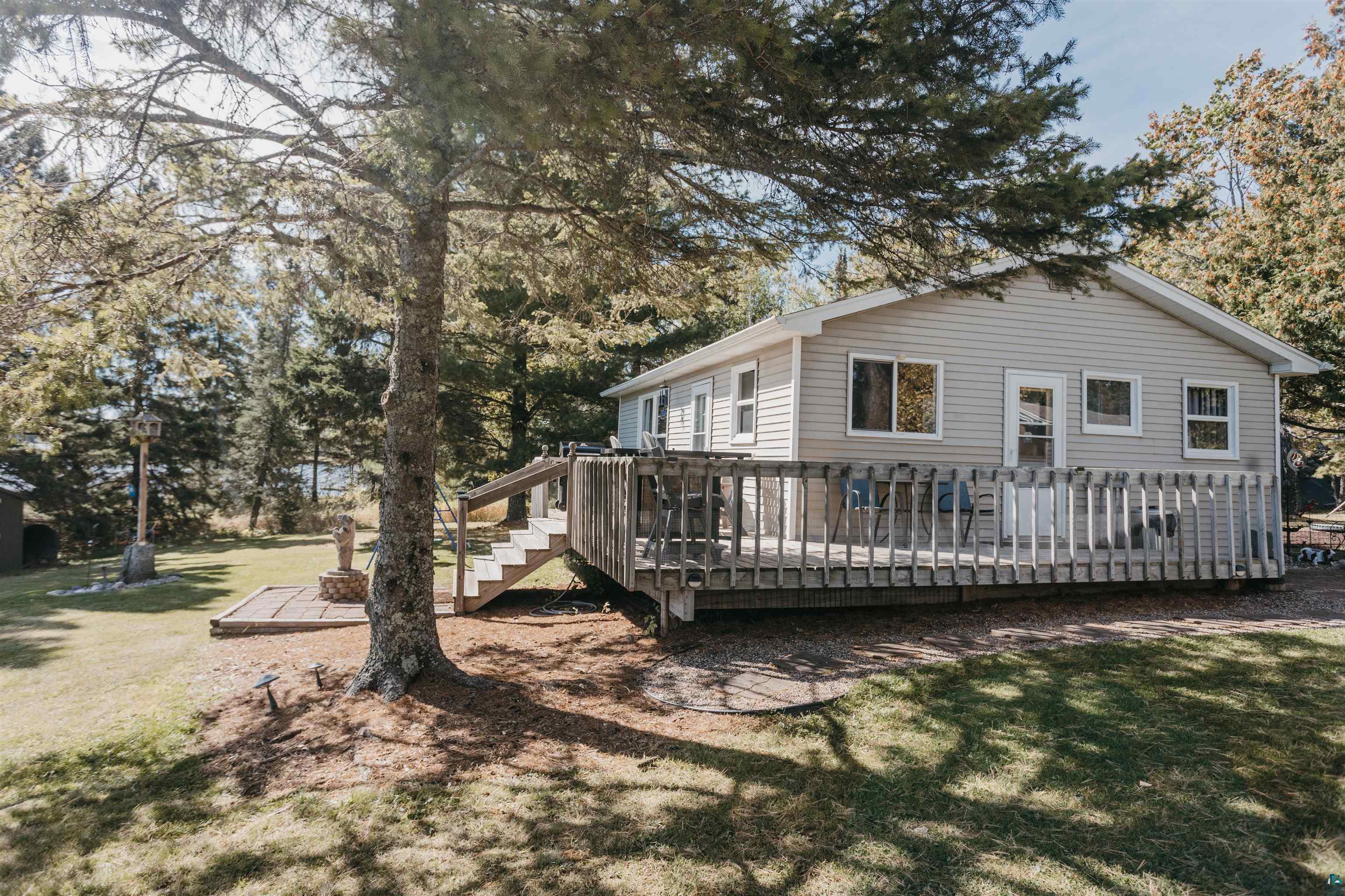 2308 South Weiberg Point Road Makinen, MN 55763 - Photo 6 of 33 View of home's exterior featuring a deck and a lawn