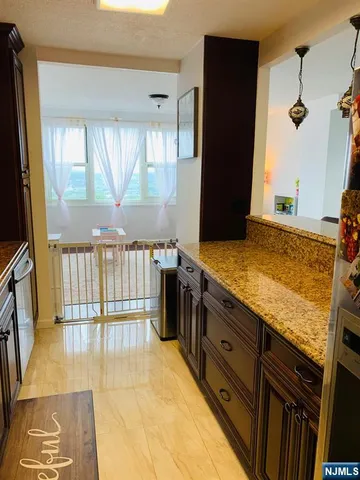 a bathroom with a granite countertop sink and a shower