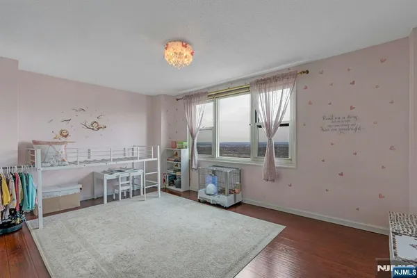 a view of a bedroom with furniture and a window