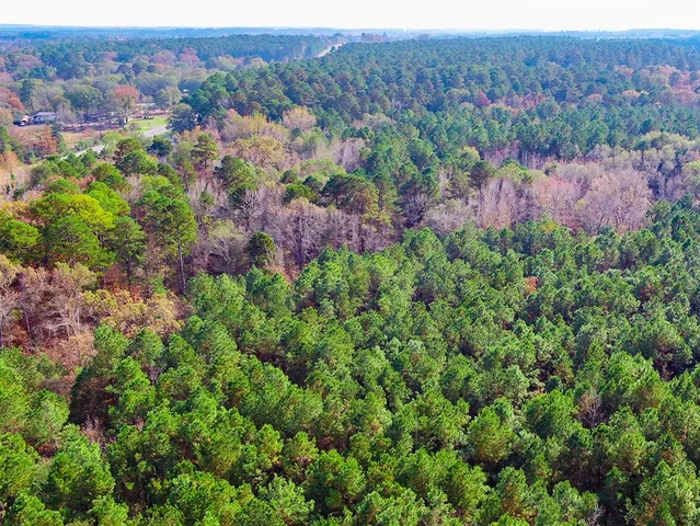 an aerial view of residential house with parking and yard