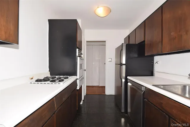 a kitchen with stainless steel appliances a refrigerator and a stove