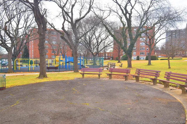 a view of swimming pool with trees and wooden fence