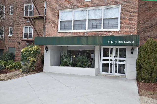 a front view of a building with a garden