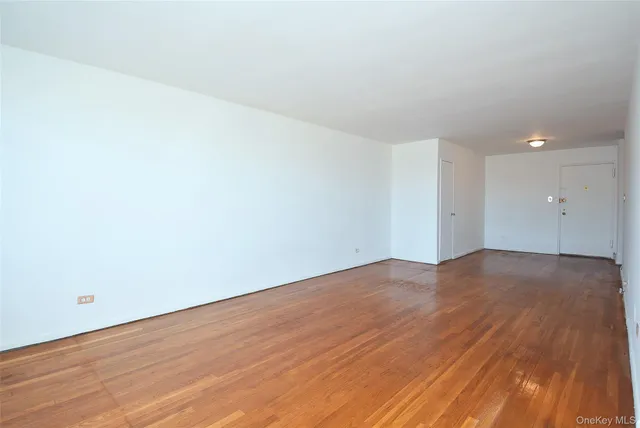 a view of an empty room and wooden floor