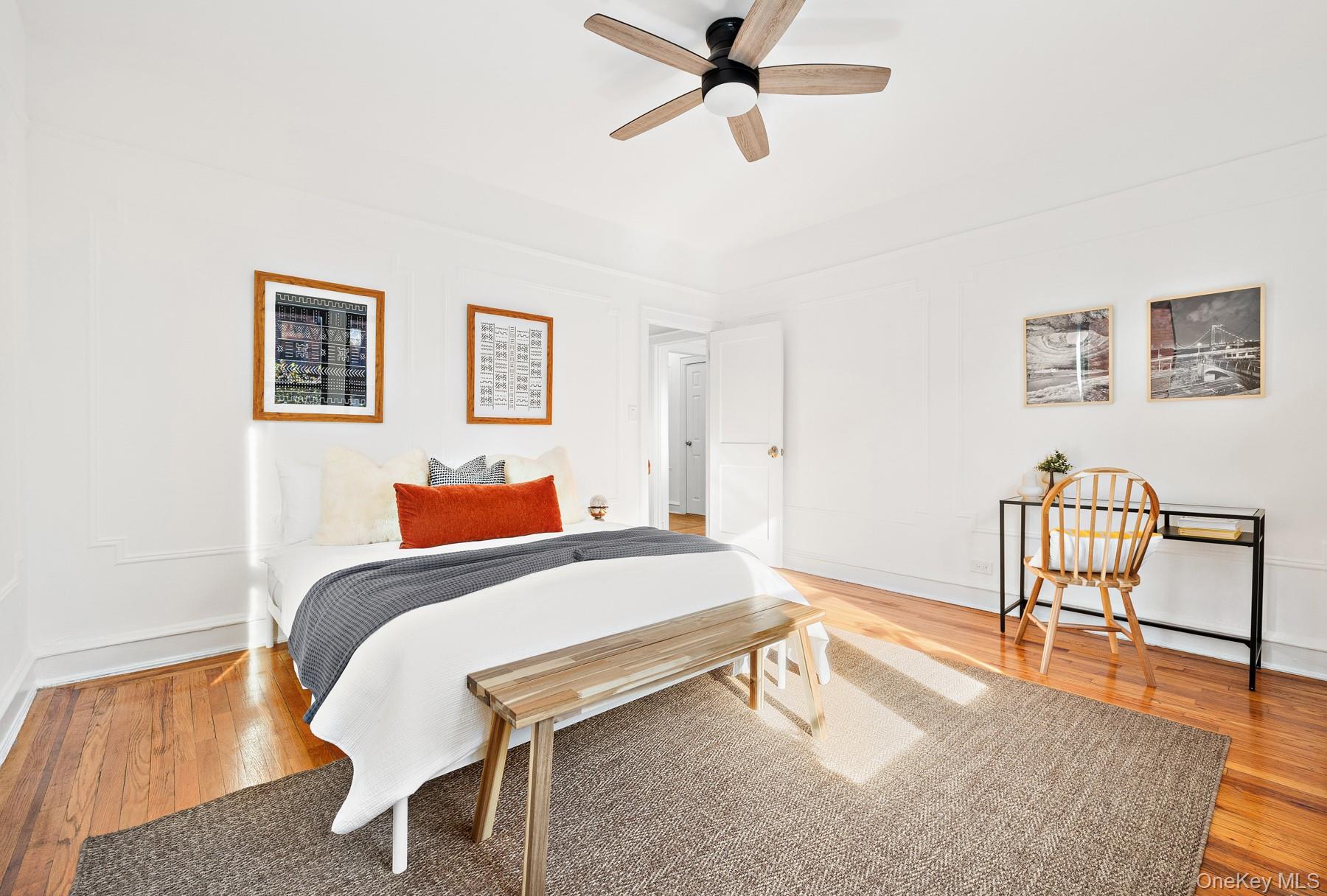41-42 42nd Street, Unit E4 Queens, NY 11104 - Photo 11 of 17 a bedroom with a bed a chair and potted plant on the table