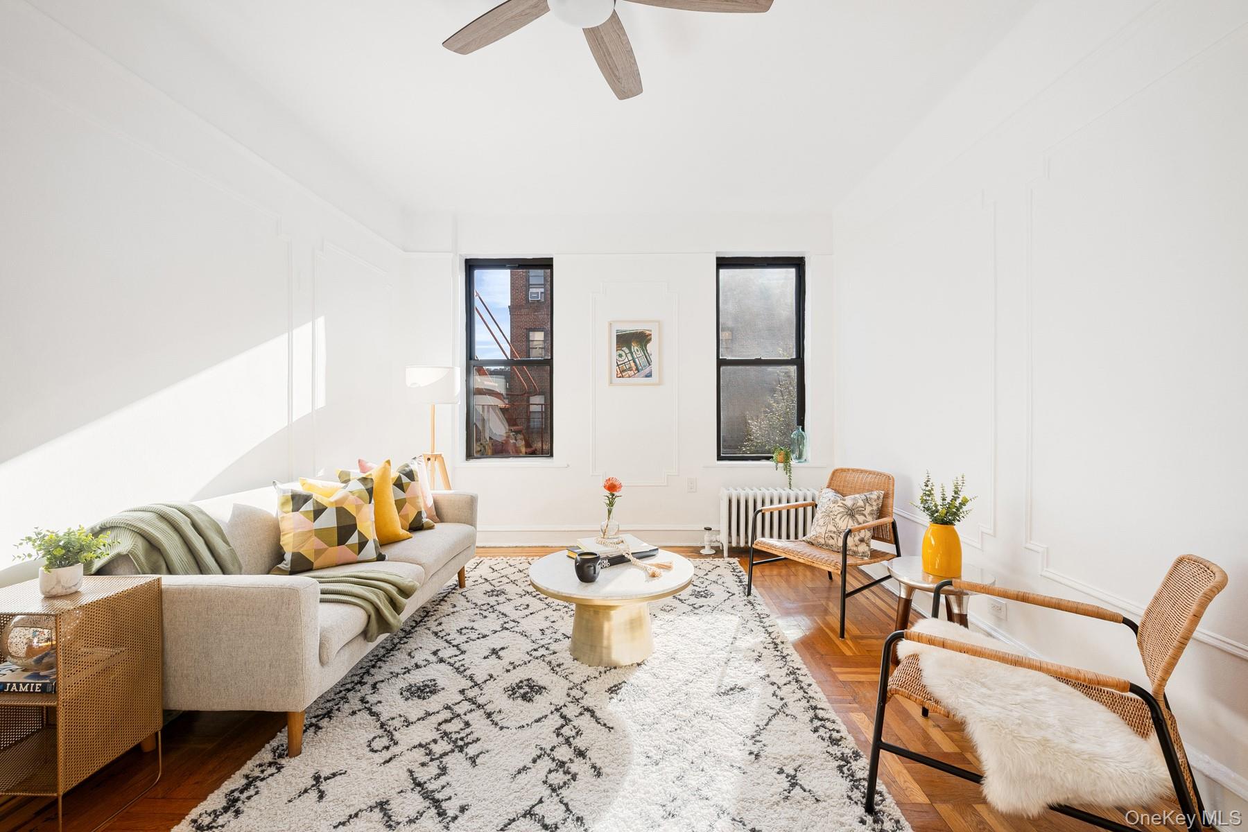 41-42 42nd Street, Unit E4 Queens, NY 11104 - Photo 2 of 17 a living room with furniture and wooden floor
