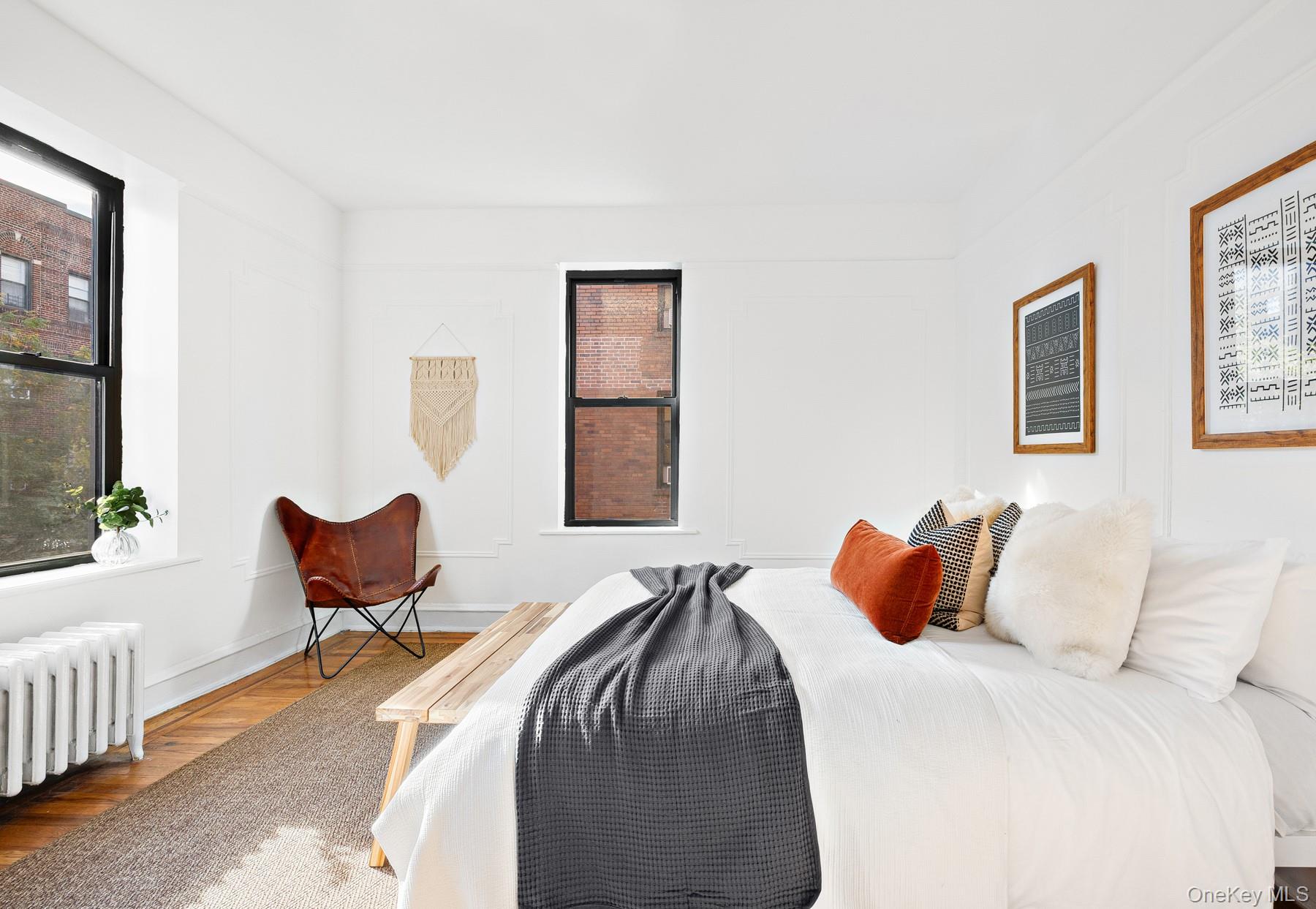 41-42 42nd Street, Unit E4 Queens, NY 11104 - Photo 10 of 17 a bedroom with a bed and chair