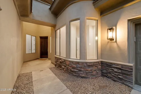 a kitchen with stainless steel appliances granite countertop a stove top oven a sink dishwasher a dining table and chairs with wooden floor