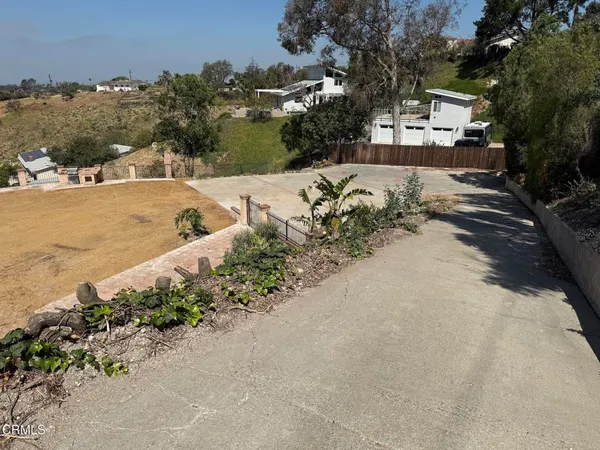 an aerial view of a house with a yard and lake view