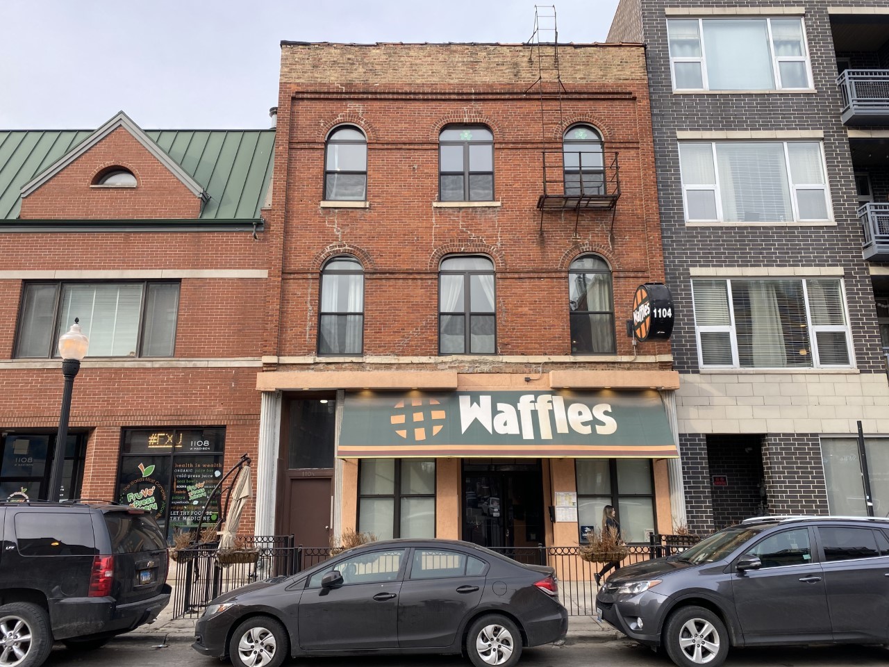 a front view of a building with parking space