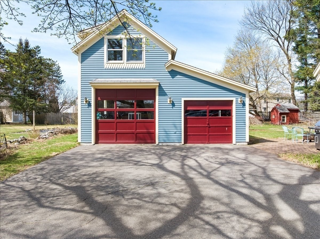 10 2nd Street Natick, MA 01760 - Photo 3 of 31 a front view of a house with a yard and garage