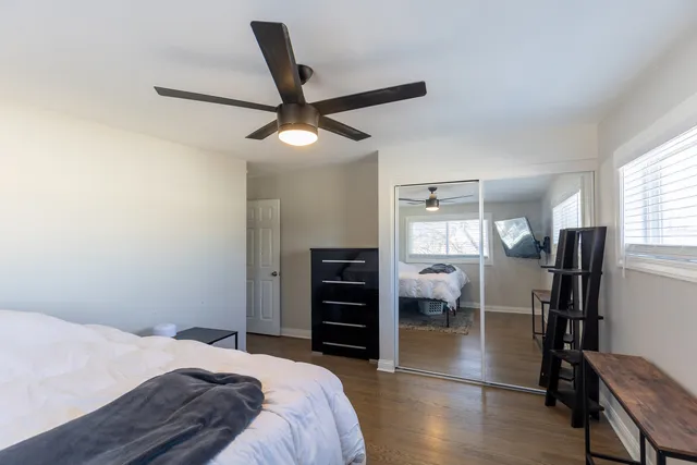 a bedroom with a bed and a view of kitchen