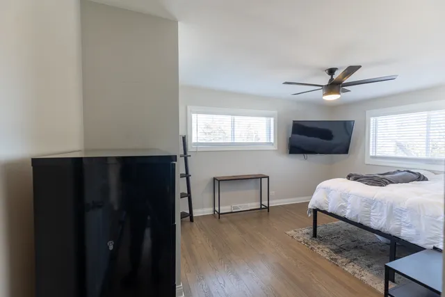 a bedroom with a bed and a flat screen tv