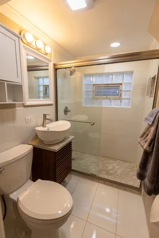 a bathroom with a sink toilet and shower