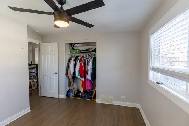 a view of a room with wooden floor and window