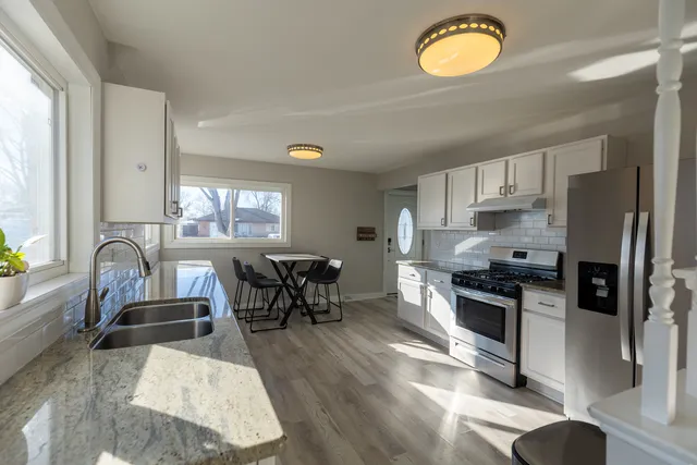 a view of kitchen with sink and microwave