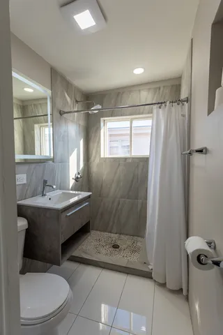 a bathroom with a sink toilet and shower