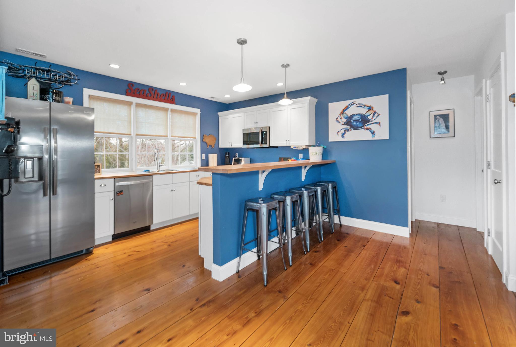 38 Virginia Avenue Earleville, MD 21919 - Photo 34 of 60 a kitchen with stainless steel appliances granite countertop a refrigerator a stove a sink and a dining table with wooden floor