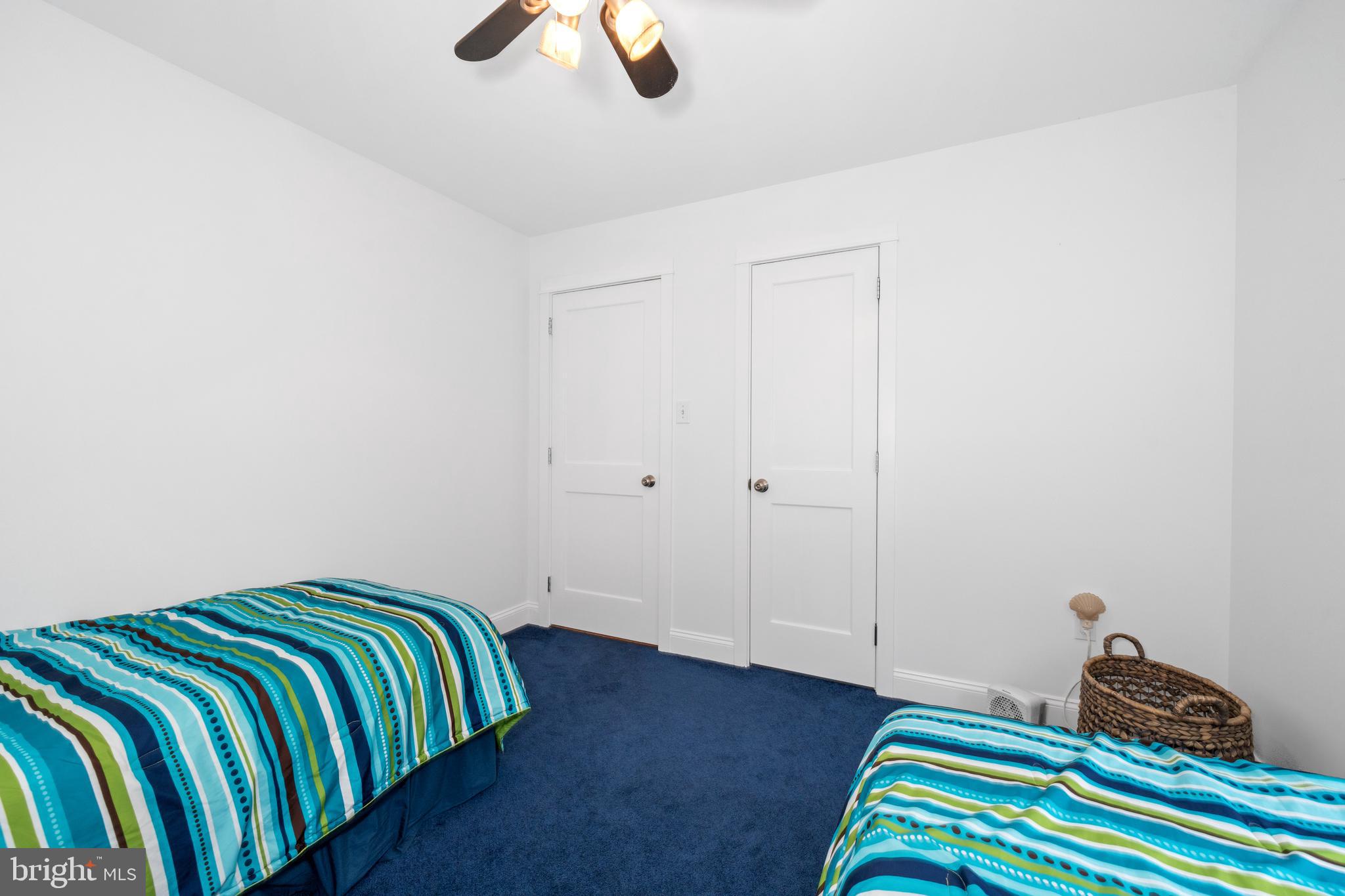 38 Virginia Avenue Earleville, MD 21919 - Photo 46 of 60 a bedroom with a bed and a chandelier