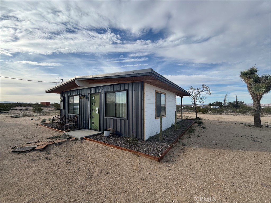 65154 Hoover Aka Mars St Road Joshua Tree, CA 92252 - Photo 1 of 11 a backyard of a house with wooden fence