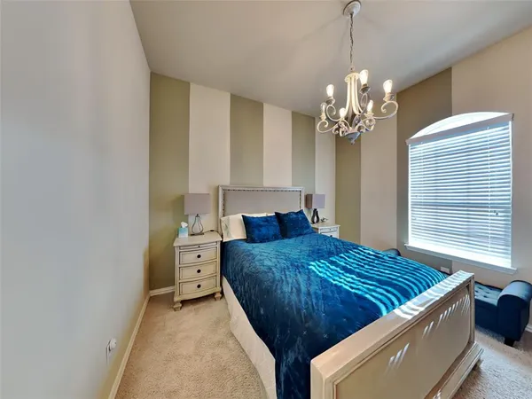 a living room with a bed and a chandelier