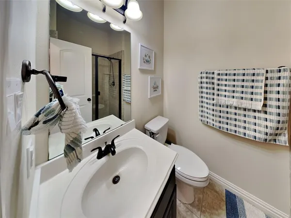 a bathroom with a sink a toilet and mirror