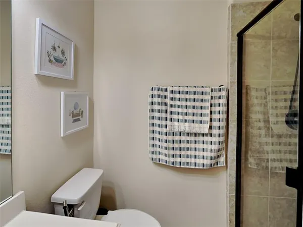 a bathroom with a toilet and a shower