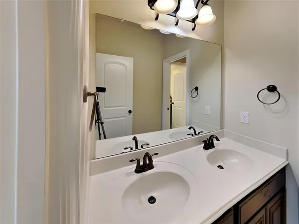 a bathroom with a sink vanity and mirror