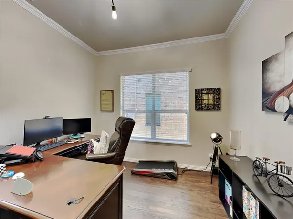 a view of a workspace with furniture and a window