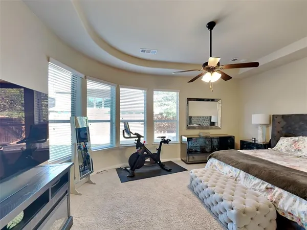 a spacious bedroom with two beds and large windows