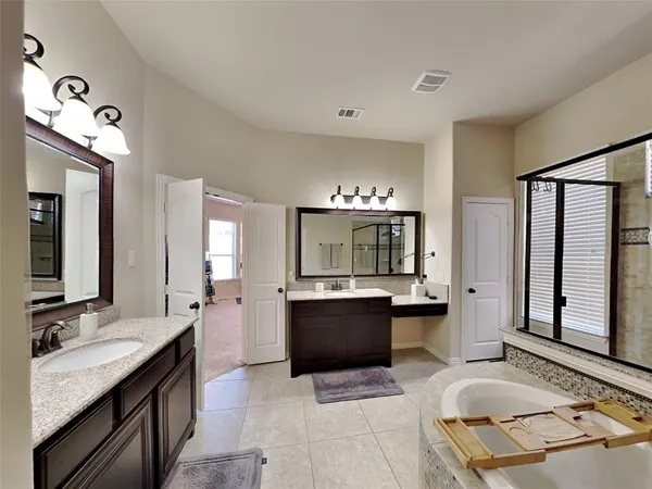 a view with kitchen island a sink wooden floor and a view of living room