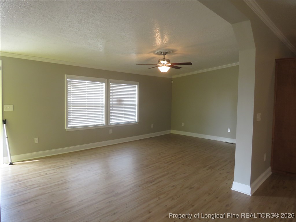 1184 Fisher Road St. Pauls, NC 28384 - Photo 12 of 29 an empty room with wooden floor and window