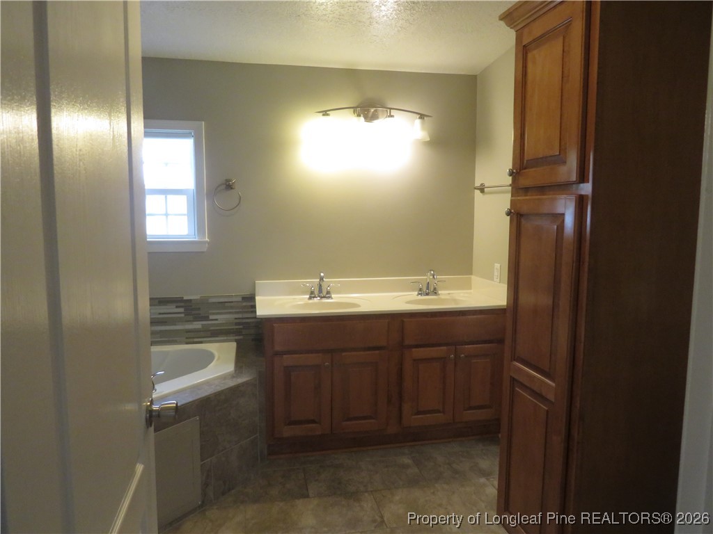 1184 Fisher Road St. Pauls, NC 28384 - Photo 16 of 29 a bathroom with a sink and a mirror