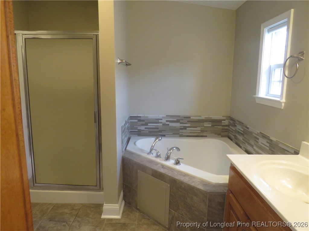 1184 Fisher Road St. Pauls, NC 28384 - Photo 17 of 29 a bathroom with a bathtub and a window