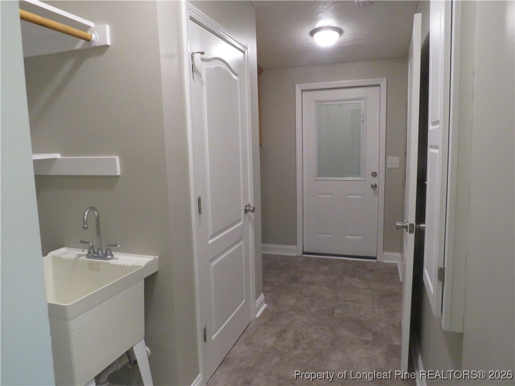 1184 Fisher Road St. Pauls, NC 28384 - Photo 18 of 29 a bathroom with a sink and mirror