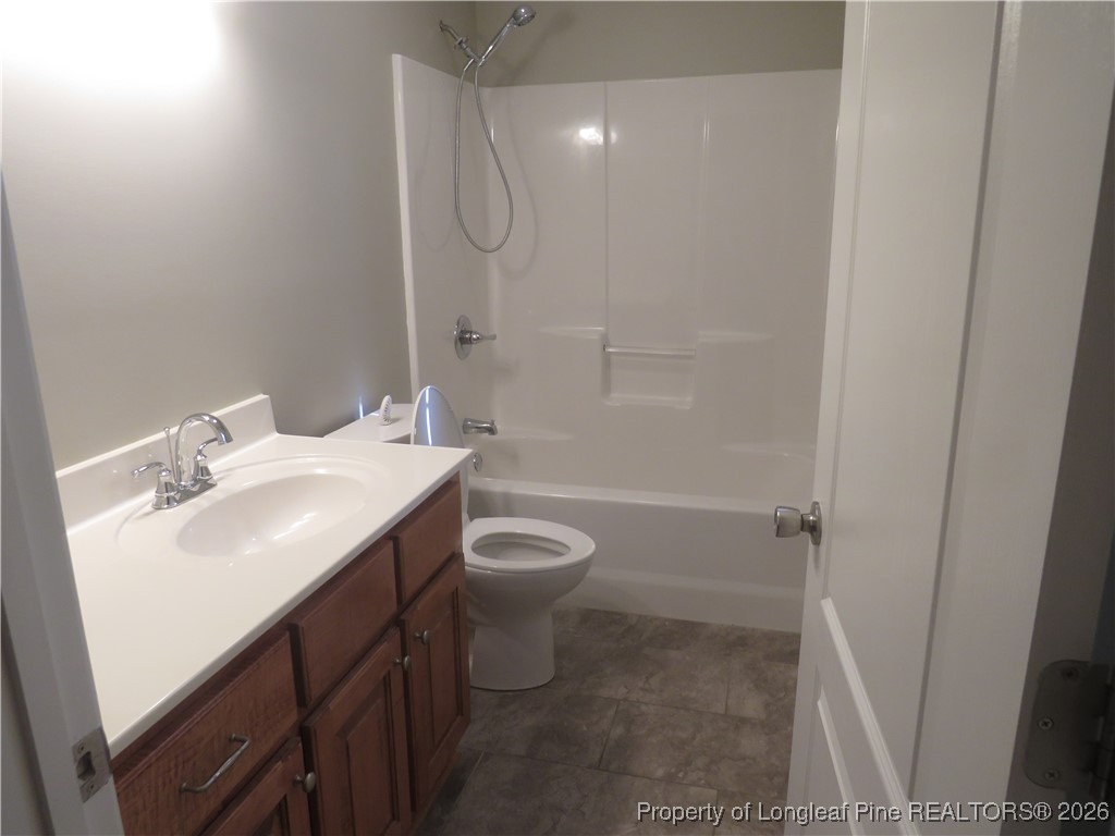 1184 Fisher Road St. Pauls, NC 28384 - Photo 19 of 29 a bathroom with a sink toilet vanity and shower