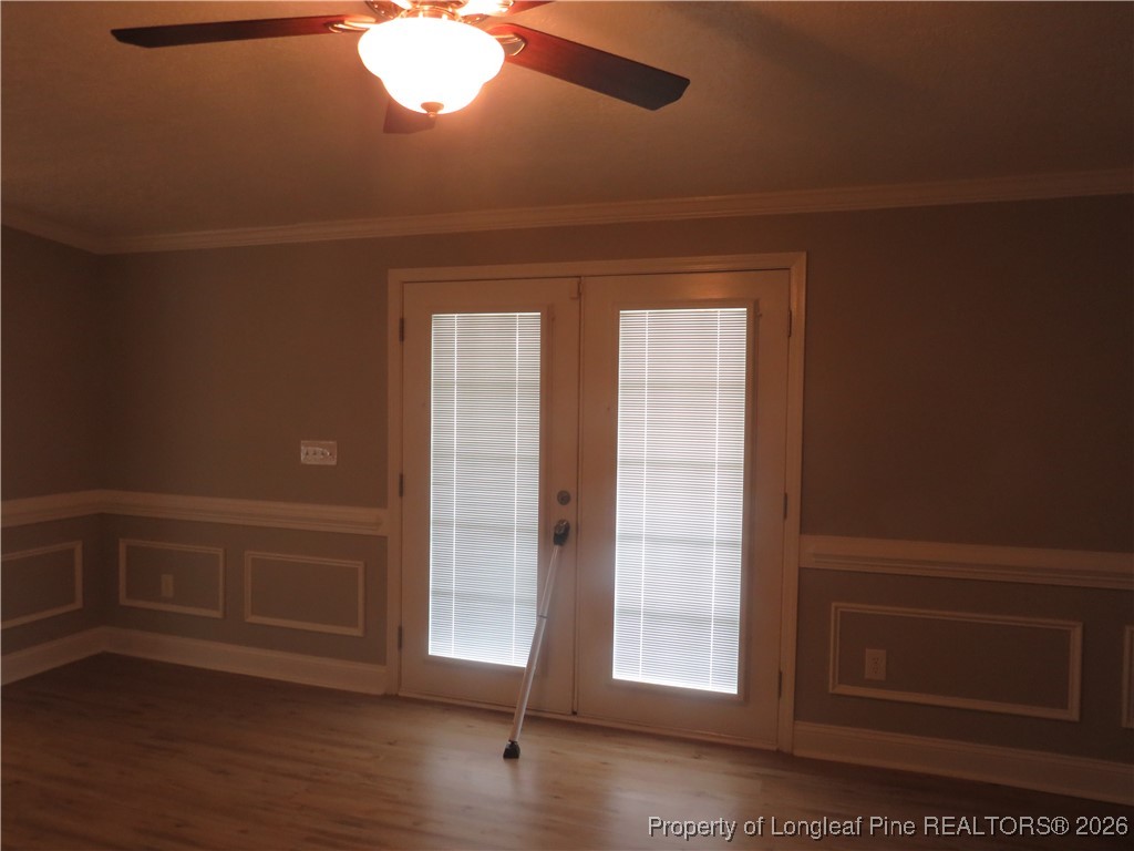 1184 Fisher Road St. Pauls, NC 28384 - Photo 23 of 29 an empty room with wooden floor and windows