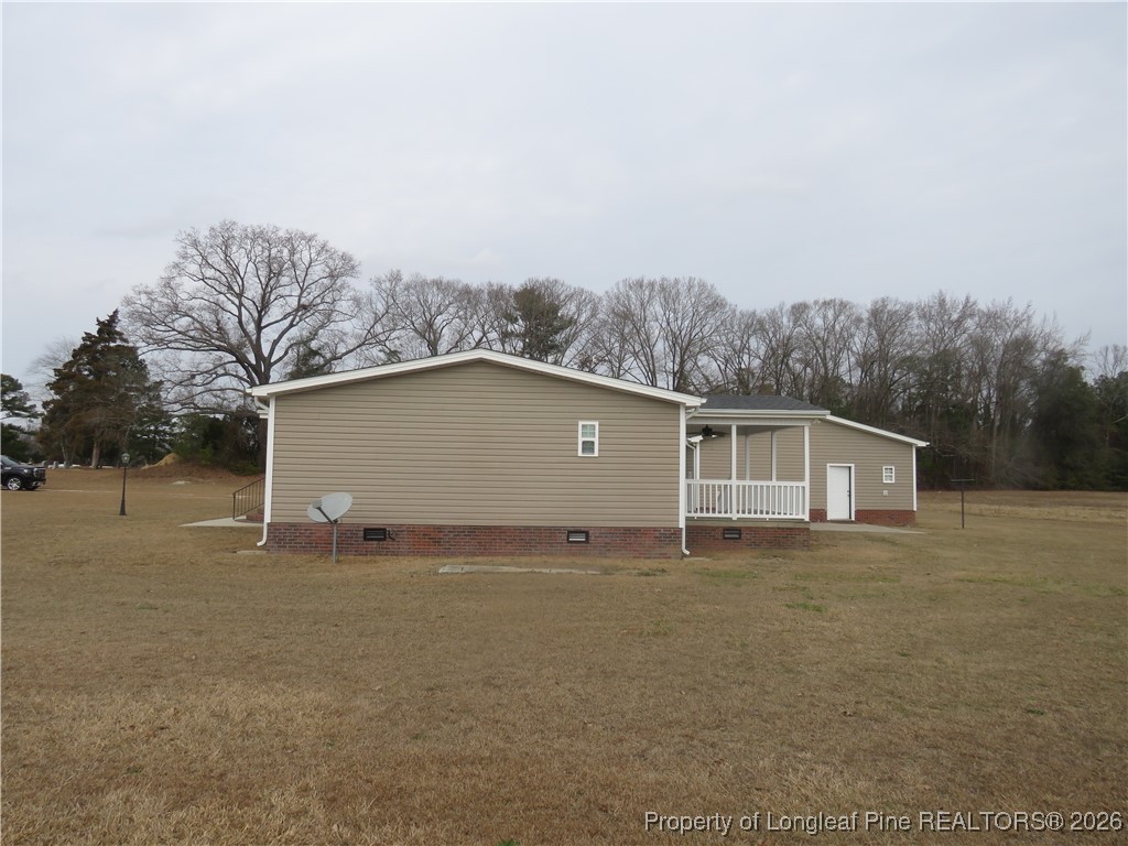 1184 Fisher Road St. Pauls, NC 28384 - Photo 3 of 29 a house with trees in front of it