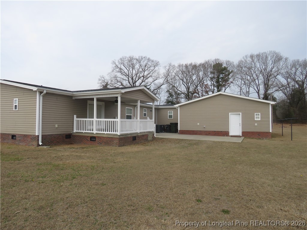 1184 Fisher Road St. Pauls, NC 28384 - Photo 4 of 29 a view of a house with a backyard and garage