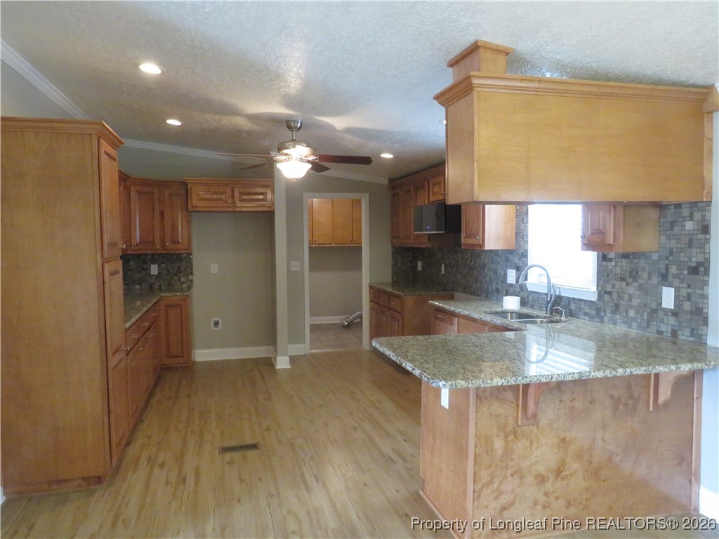 1184 Fisher Road St. Pauls, NC 28384 - Photo 8 of 29 a kitchen with stainless steel appliances granite countertop a sink refrigerator and cabinets