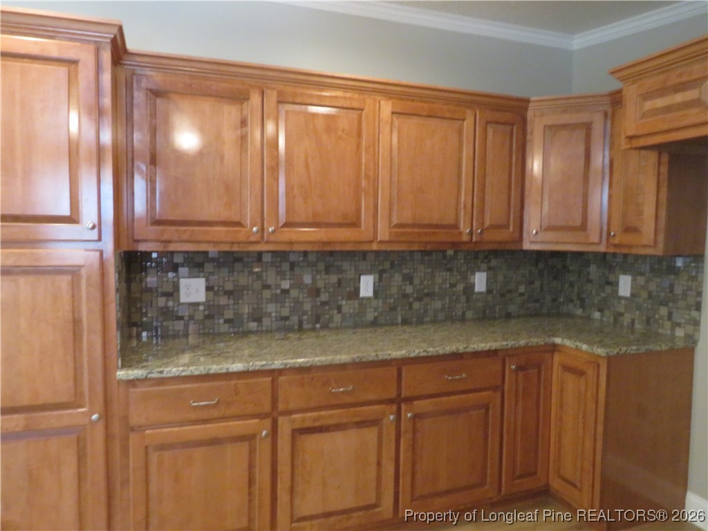1184 Fisher Road St. Pauls, NC 28384 - Photo 9 of 29 a kitchen with granite countertop cabinets and white stainless steel appliances