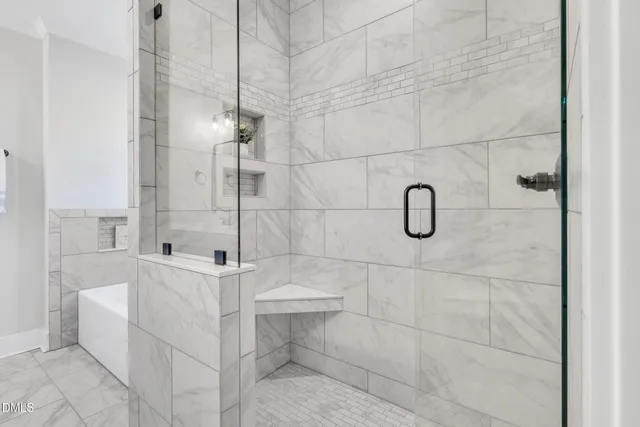 a bathroom with a bathtub and shower