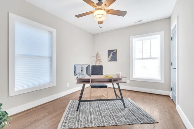 a work room with a window and wooden floor