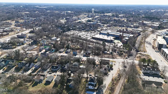 an aerial view of residential houses with city view
