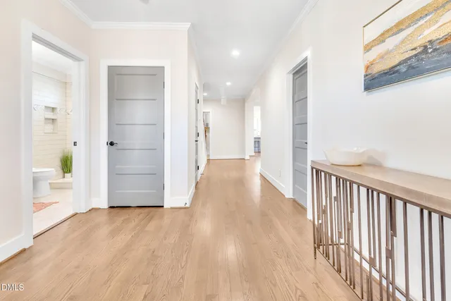 a view of a hallway with wooden floor