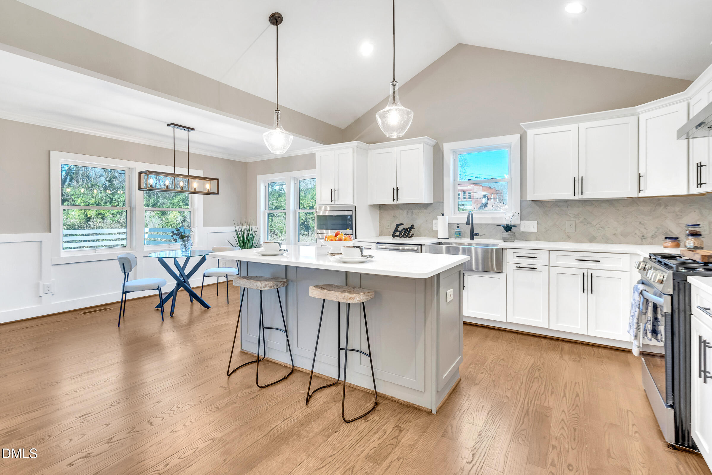 701 Eva Street Durham, NC 27701 - Photo 7 of 29 a kitchen with a table chairs refrigerator and cabinets