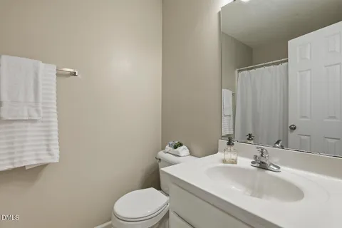 a bathroom with a sink toilet and mirror