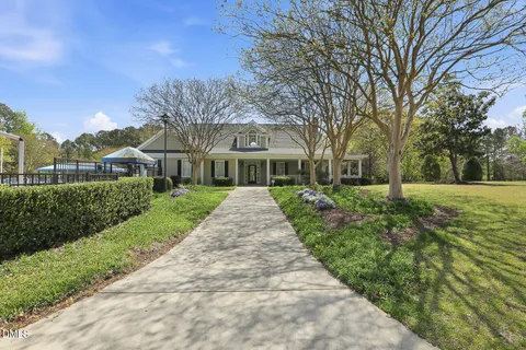 a view of a brick house with a yard